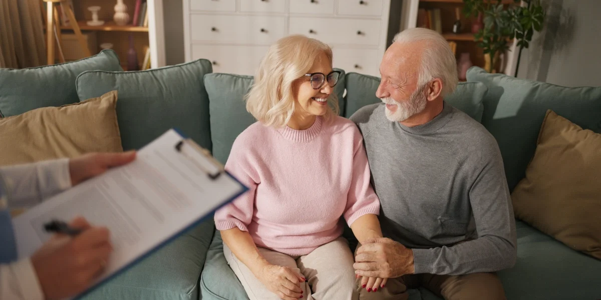 Senior couple talking with team member