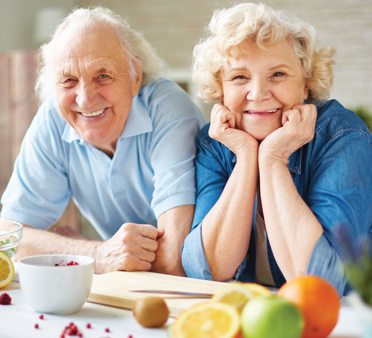 Couple preparing a healthy snack in their cottage kitchen.