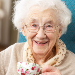Happy Senior woman with a warm cup of tea