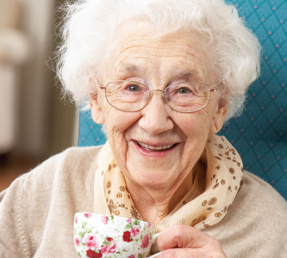 Happy Senior woman with a warm cup of tea