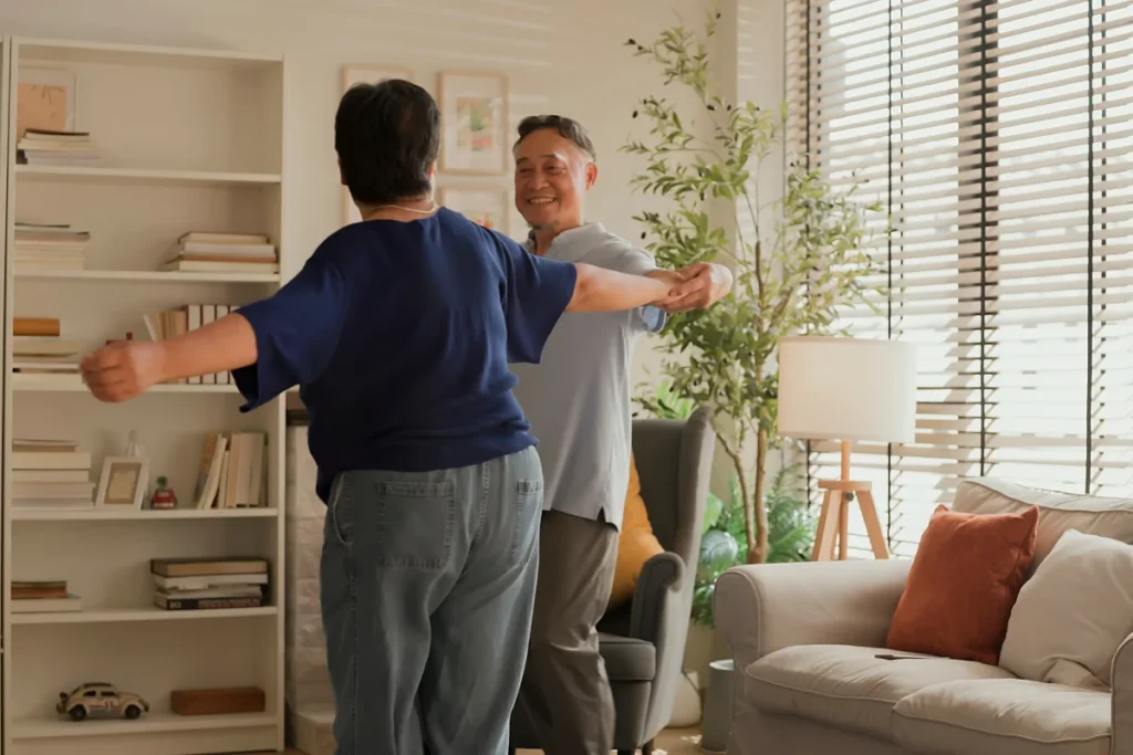 Senior couple dancing in apartment