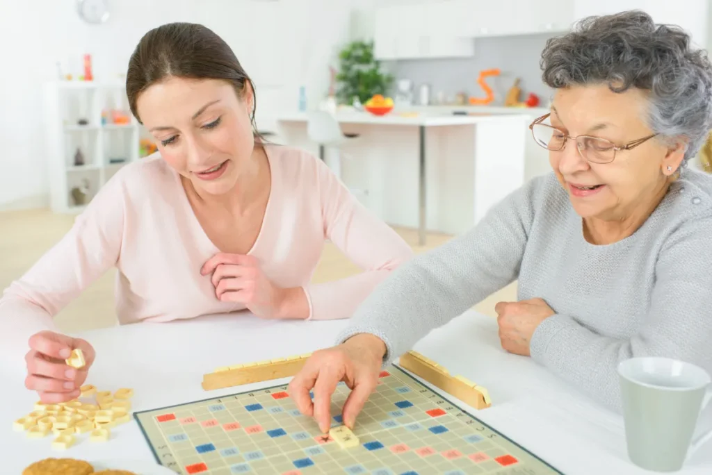 Senior woman playing board game with relative