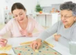 Senior woman playing board game with relative